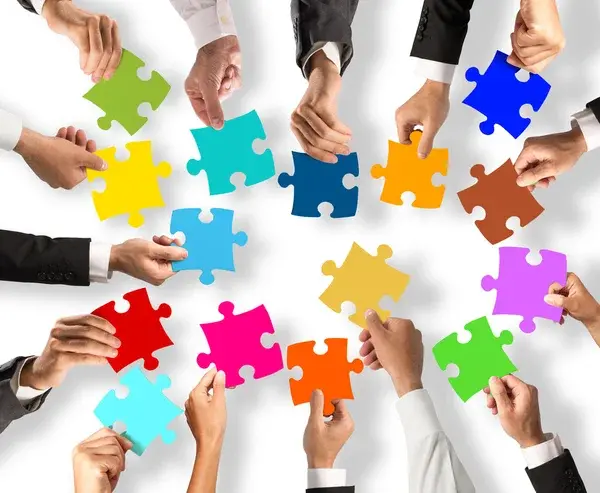 Depositphotos 123717198 stock photo people holding the colorful puzzle